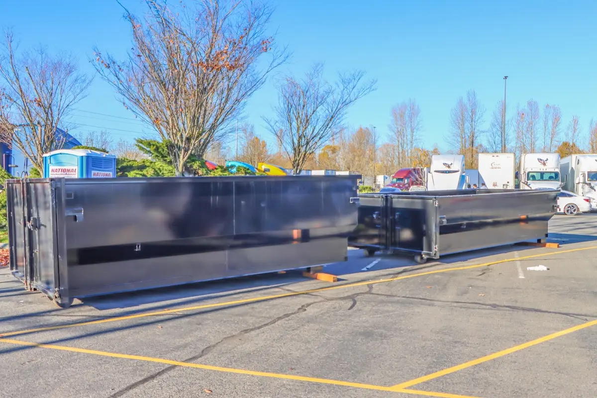 Professional dumpster rental service with roll-off container on residential driveway in Cold Springs